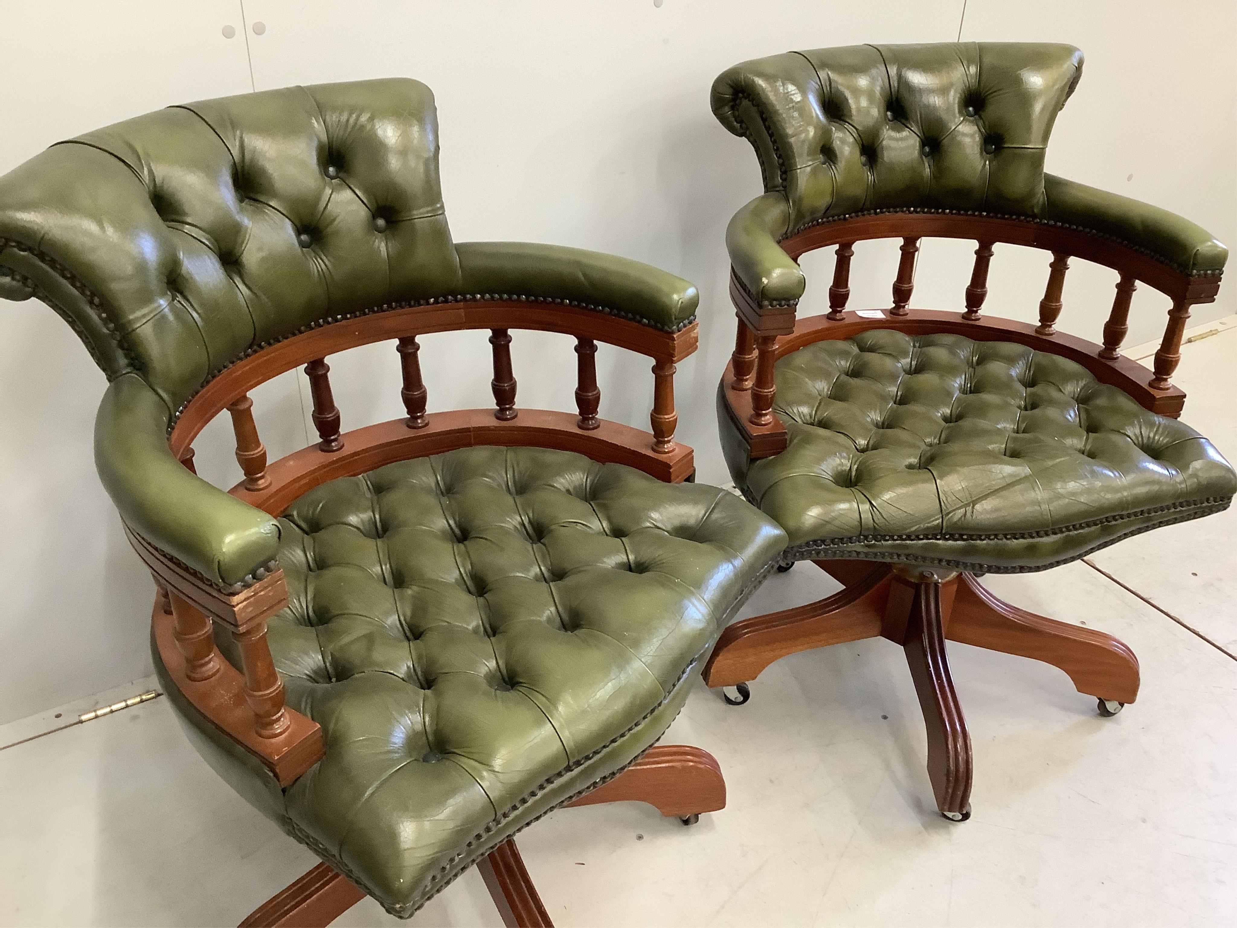 A pair of reproduction Victorian style buttoned green swivel desk chairs, width 61cm, depth 55cm, height 84cm